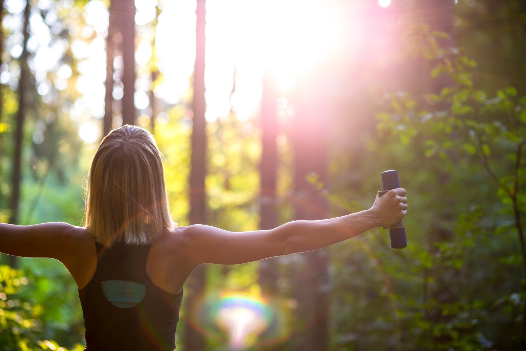 Woman with Dumbbells in Forest